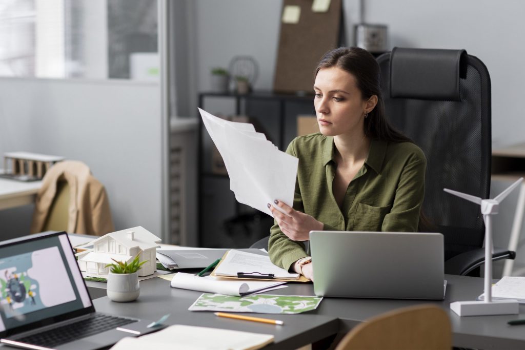 Freelancer organizing tax documents and invoices at a desk for 1099 self-employment tax filing