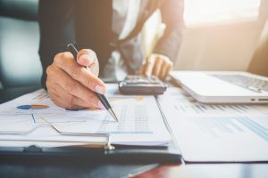 Entrepreneurs reviewing financial reports and tax planning strategy