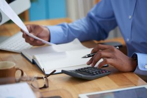 Entrepreneur reviewing financial reports and tax planning documents
